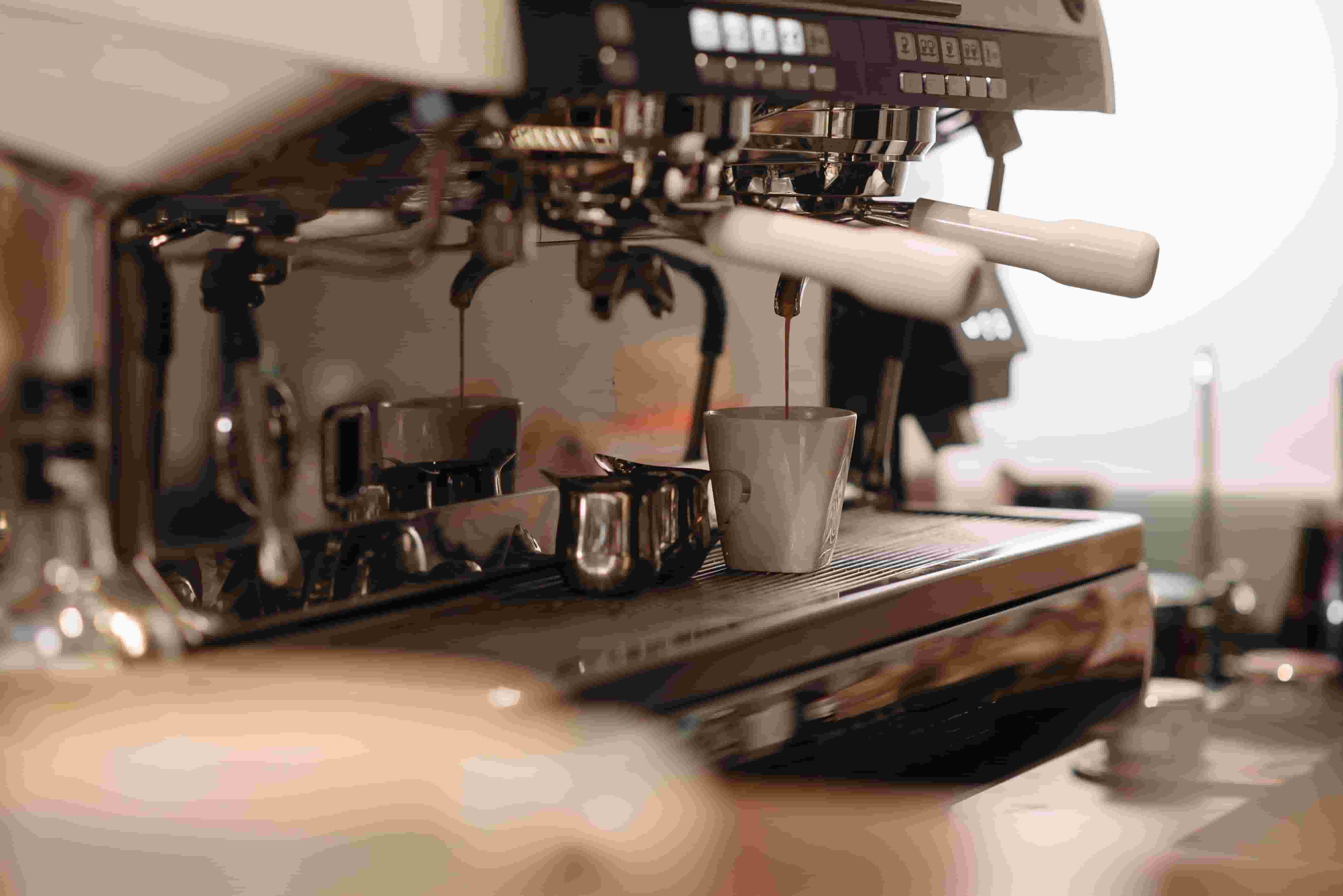 Espresso machine pulling a shot, the kind of equipment a breakdown claim can shut a coffee shop down without
