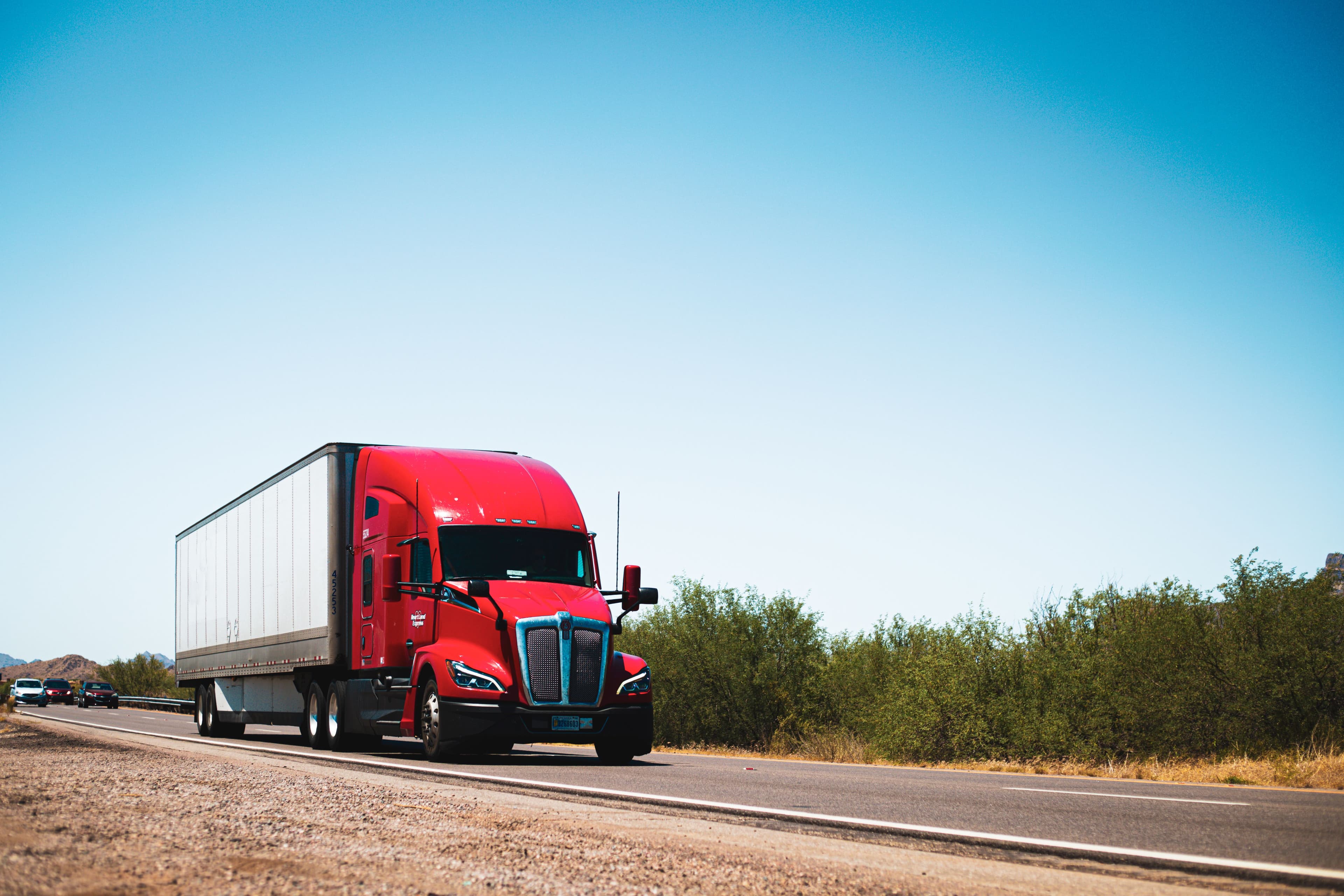 Illustration of a commercial truck and shield for Pennsylvania trucking insurance coverage