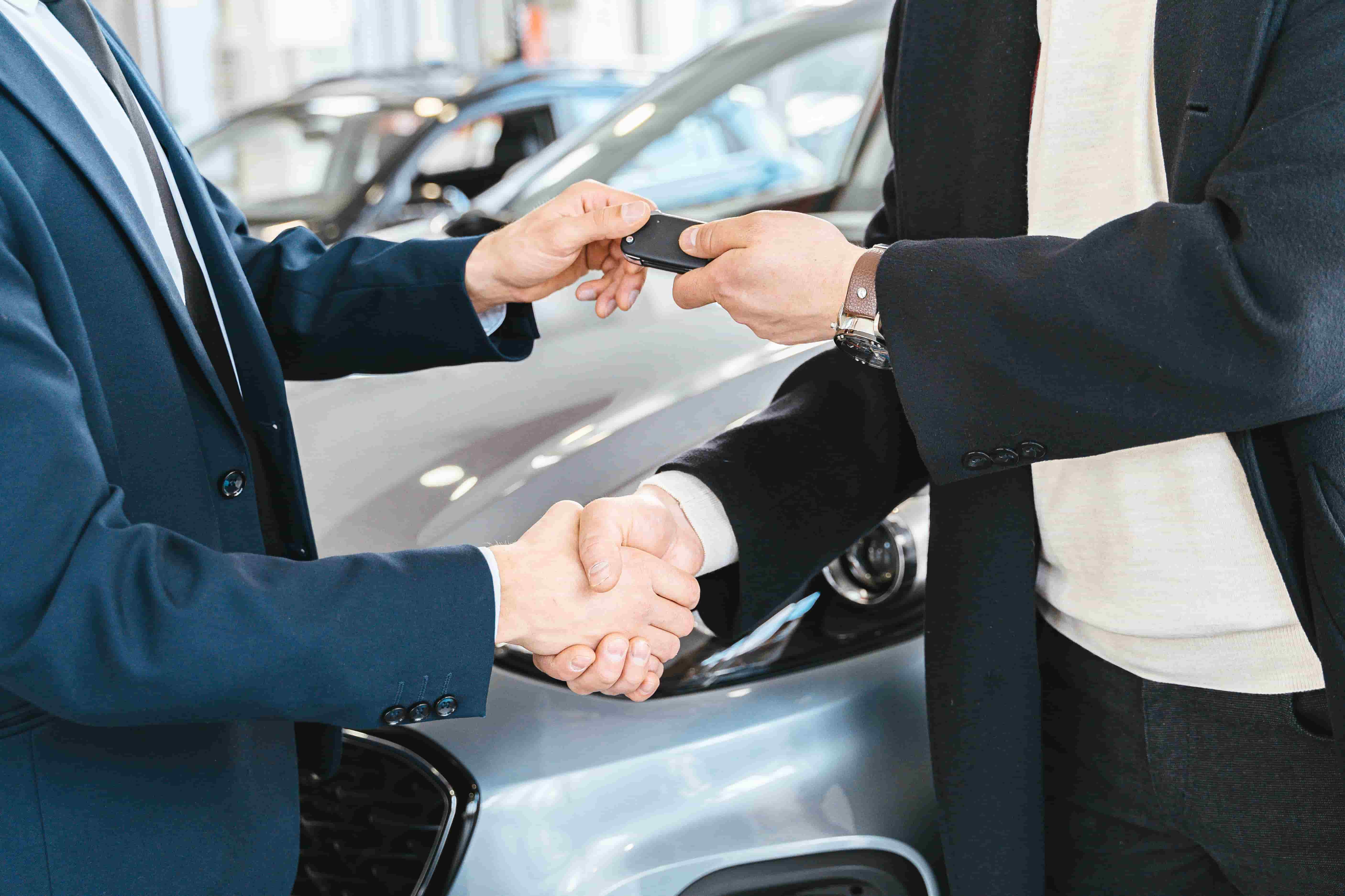 Car keys handed to a new owner, representing auto insurance in Lexington, Kentucky