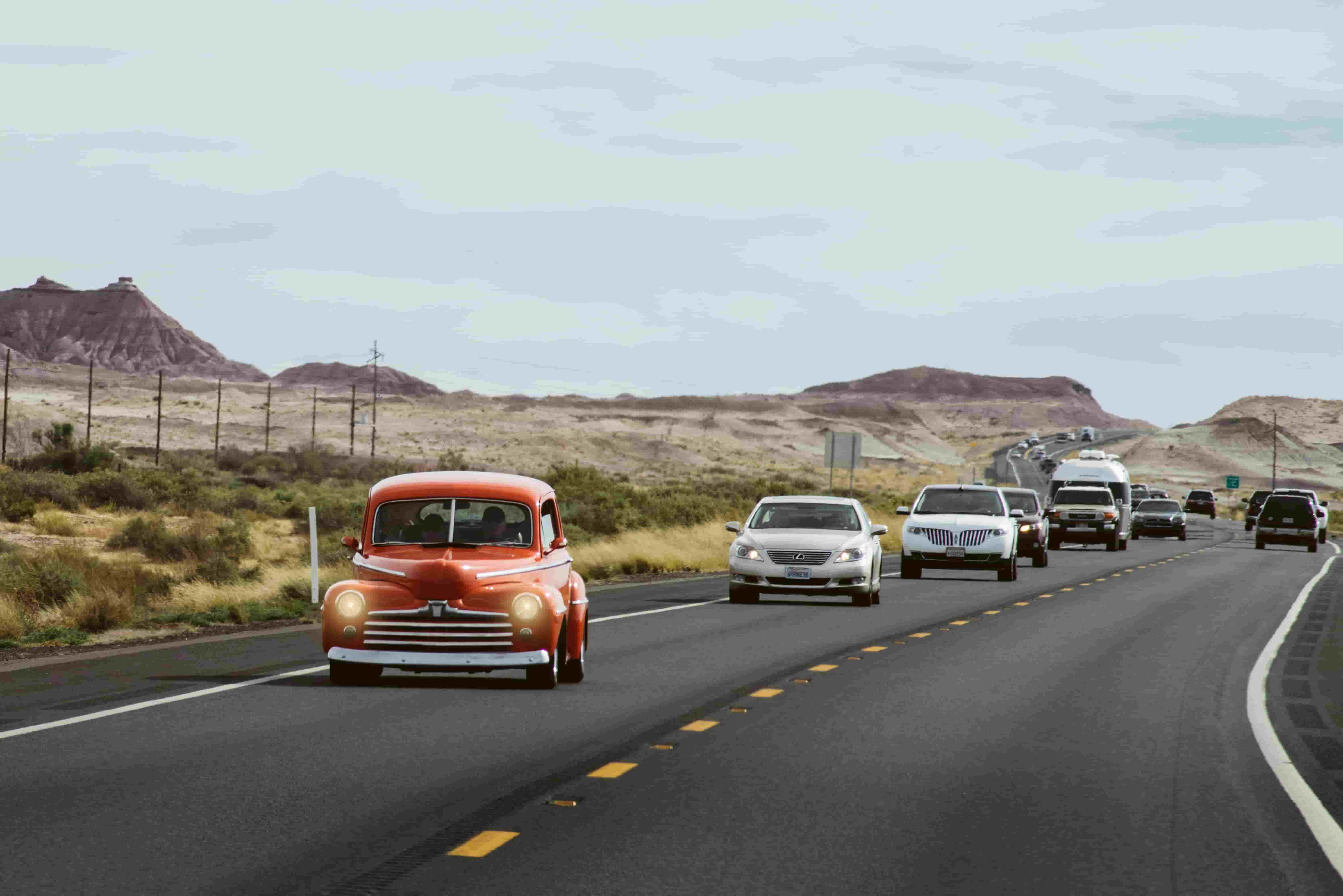 Car travelling on an open highway, representing comparing auto insurance quotes across carriers