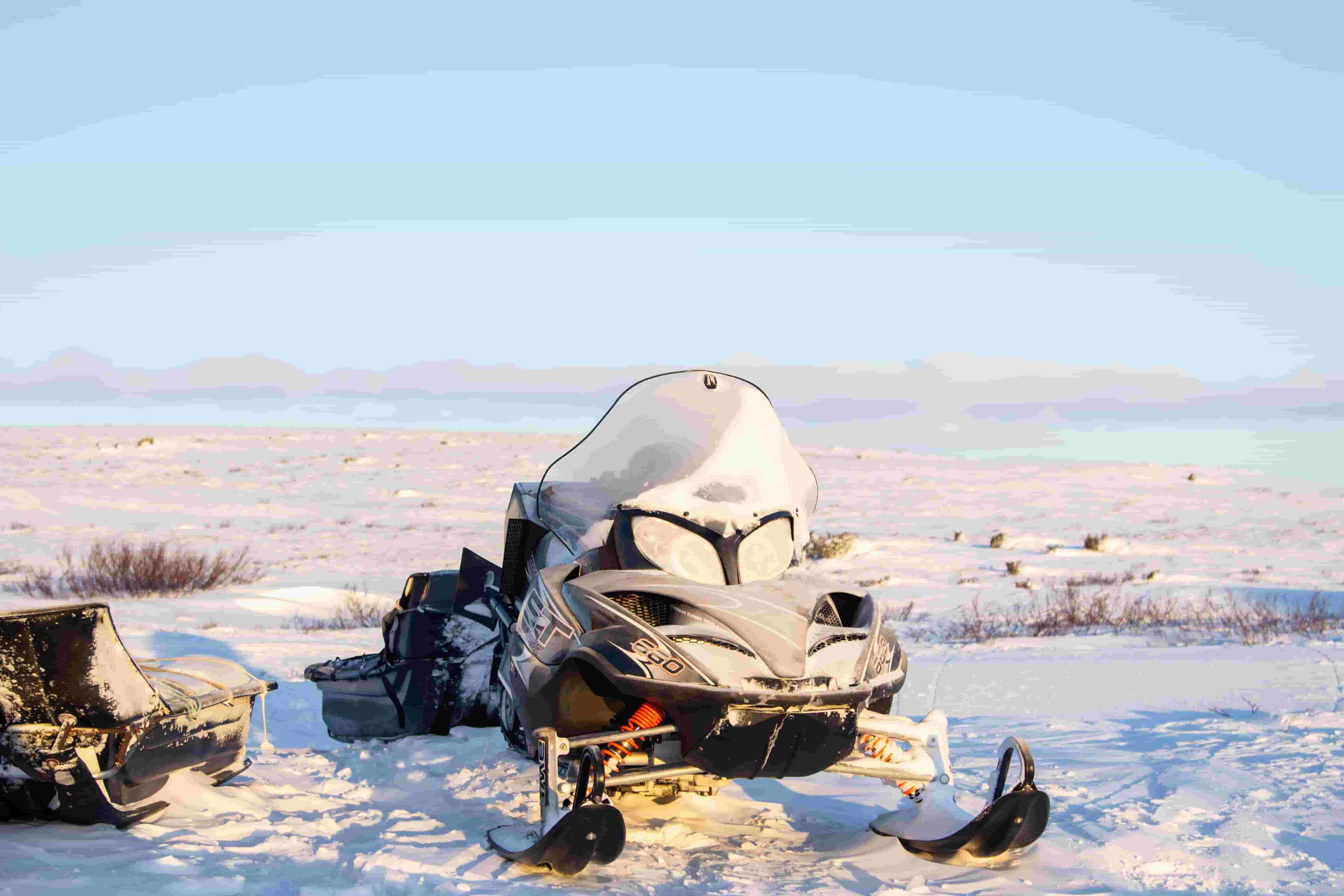 Snowmobile parked on a snow-covered field