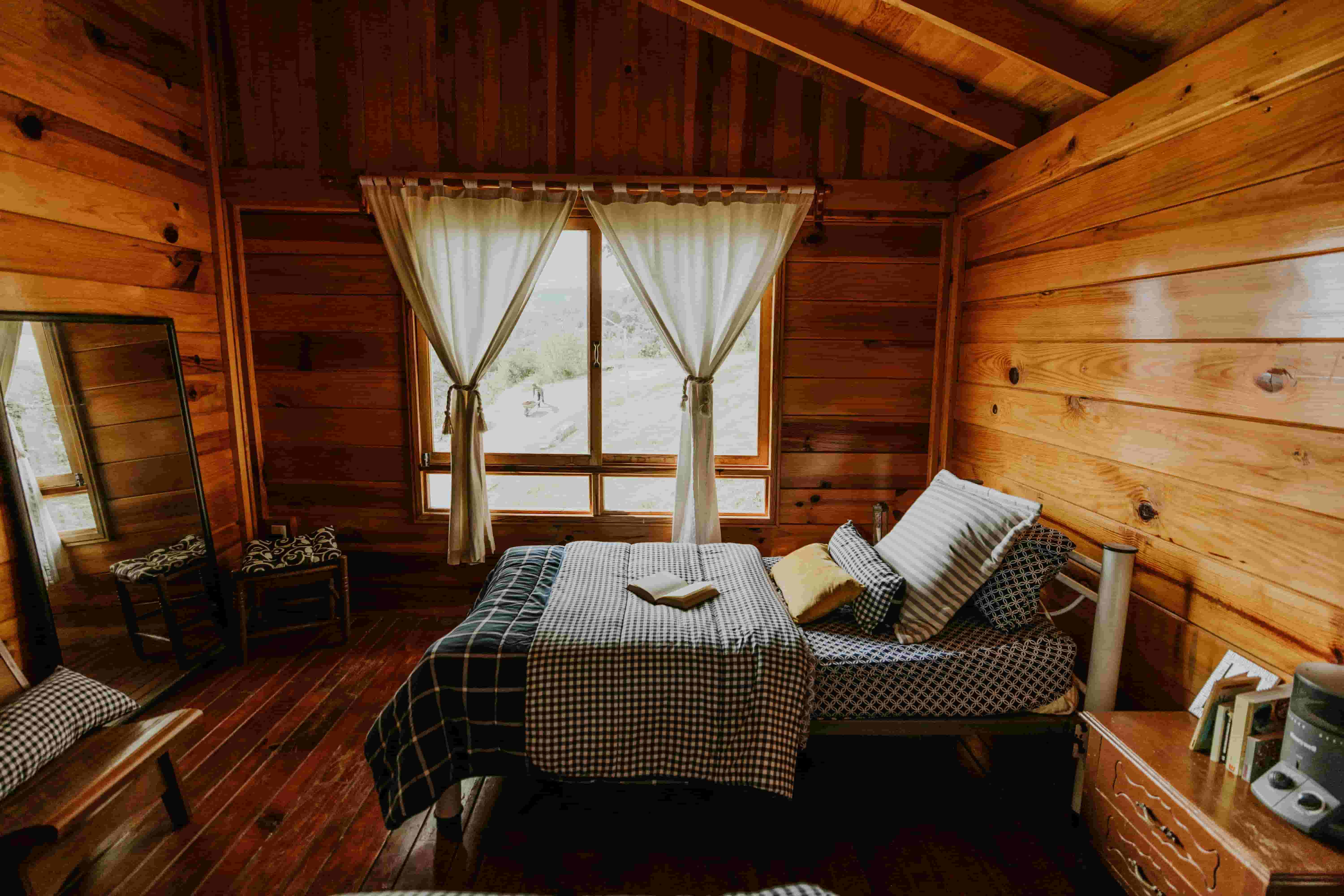 Cozy wood cabin bedroom set up as a short-term vacation rental