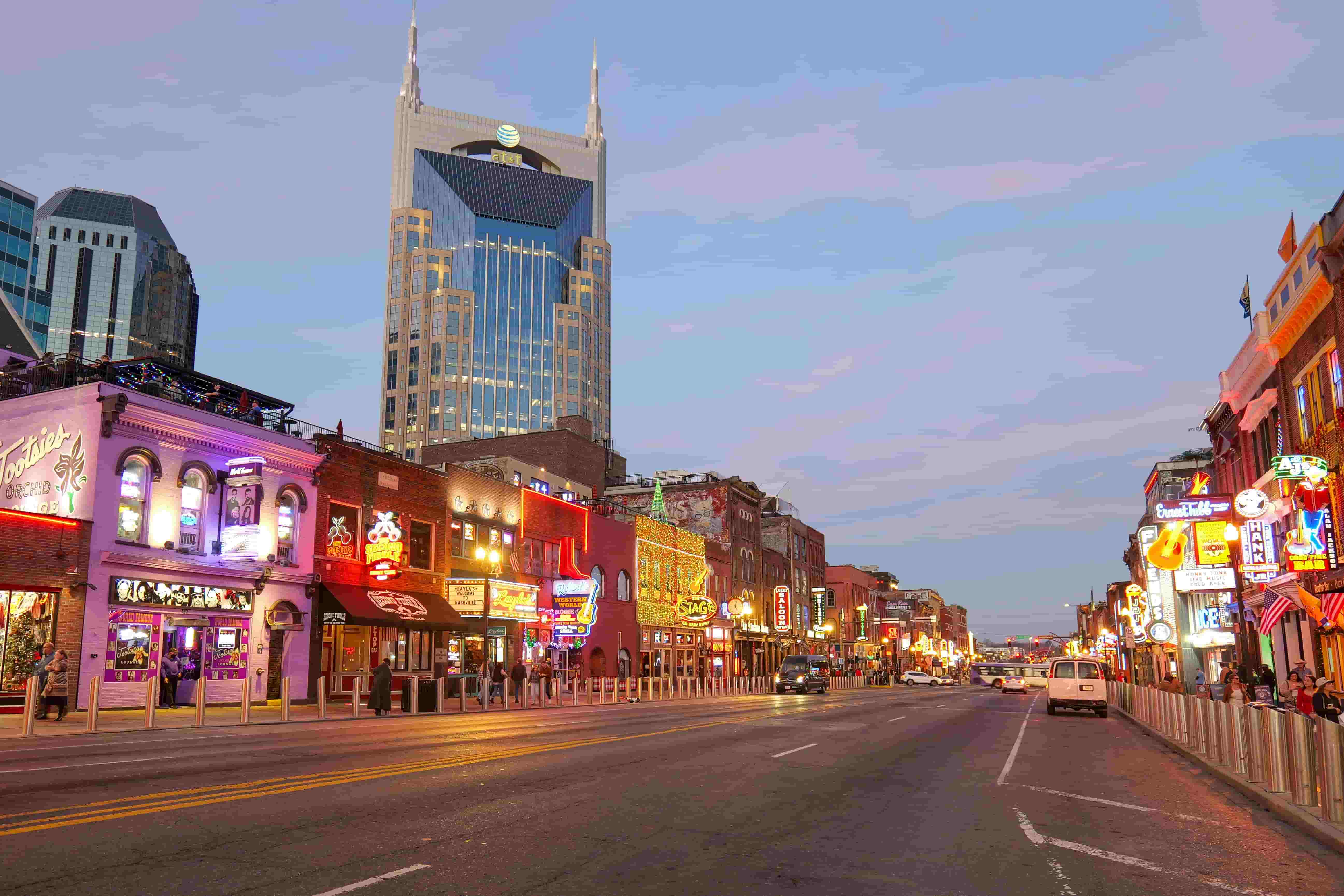 Neon-lit honky-tonks along Broadway in downtown Nashville at dusk